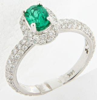 18 KARAT WHITE GOLD OVAL EMERALD AND CANADIAN DIAMOND HALO RING