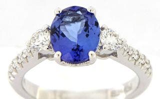 18 KARAT WHITE GOLD OVAL TANZANITE AND DIAMOND RING